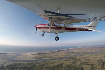 Rondvlucht vliegtuigje in. de lucht boven Texel